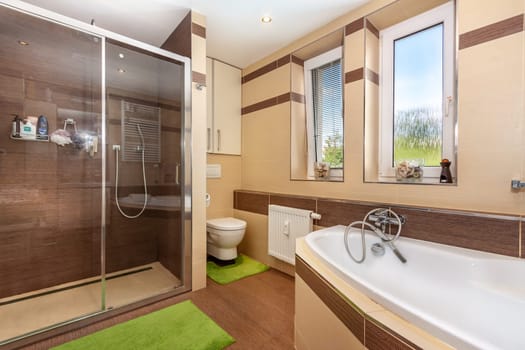 modern bathroom in the apartment. A glass shower door. High quality photo
