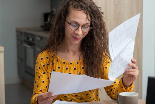 a young woman looking at received mail at home
