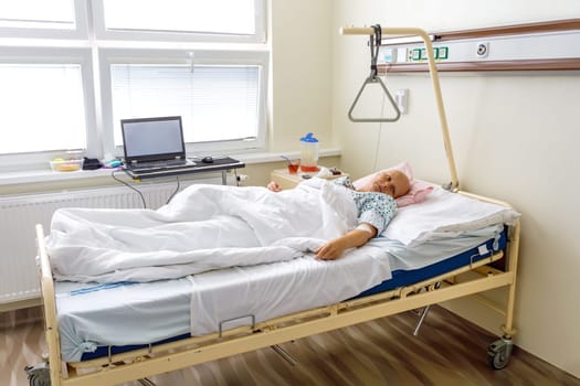 Middle age woman without hair after chemotherapy patient lying at hospital bed feeling sad and depressed worried. Disease feeling sick in health care and clinical attention concept.