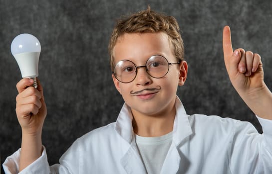 cute smiling child boy with a light bulb