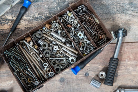 a plastic toolbox with small screws