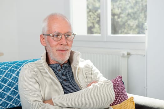 portrait of senior with white hairs wearing eyeglasses