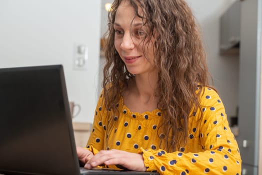 a smiling young woman using laptop