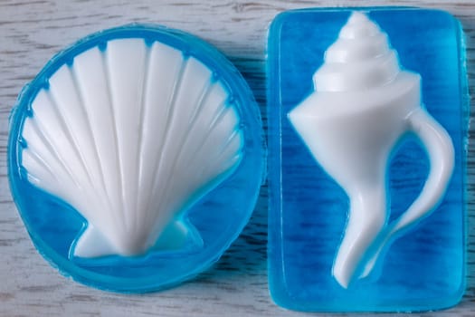 Glycerin base soap handmade with a white shell on a blue transparent base lying on the table
