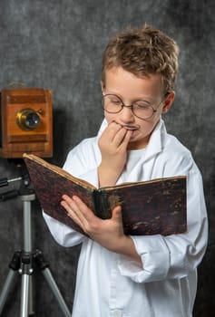 cheerful boy retro with a white blouse reading a book