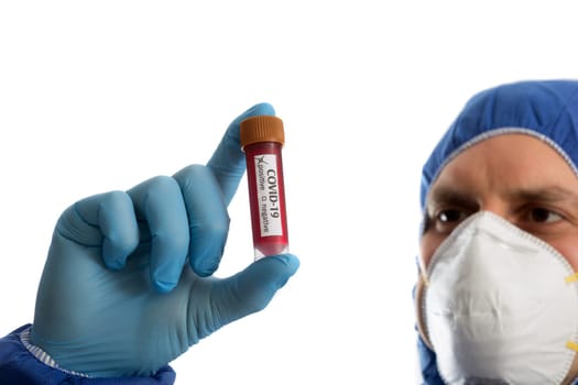 Doctor in protective clothing looking on blood sample with positive marker. COVID -19 virus.