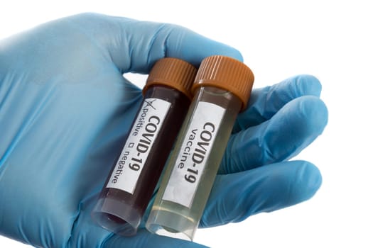 Blood test tube and vaccine in doctor hand with blue medical gloves.