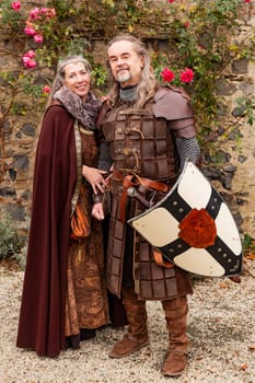 Couple posing robed in beautiful medieval clothing
