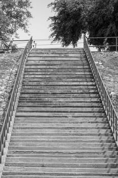 concrete cement  stairs steps outdoors sunny handrail black white