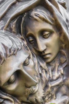 Bronze Statue of dead Jesus Christ down from the cross, being embraced by the Virgin Mary. It can be used for concepts and events.