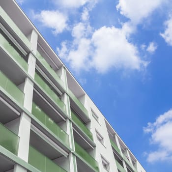 Facade of a modern apartment building. Modern apartment buildingn on a sunny day with a blue sky.