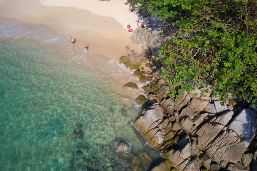 Aerial drone top view of turquoise sea surface with stones and rocks in water