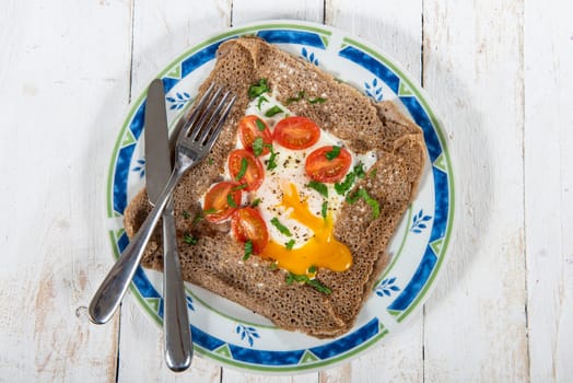 aa Breton crepe with egg and tomatoes