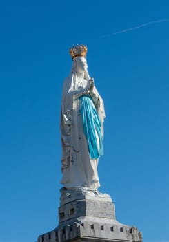 view of Virgin of Lourdes on the blue sky, France