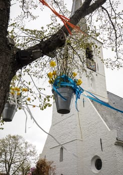 Noordwijkerhout, Netherlands - April 23,  2017: Decorations with hanging pails with yellow daffodils at the traditional flowers parade Bloemencorso from Noordwijk to Haarlem in the Netherlands