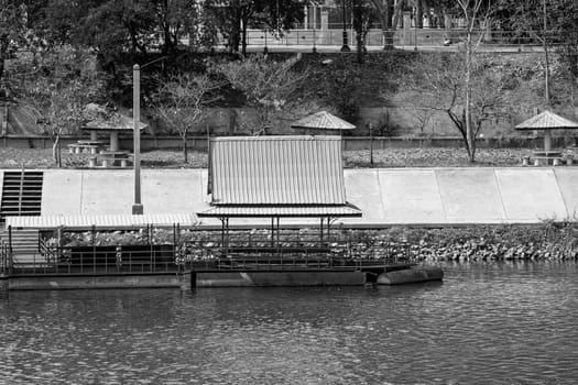 floating platform roof metallic structure leisure activity river black white