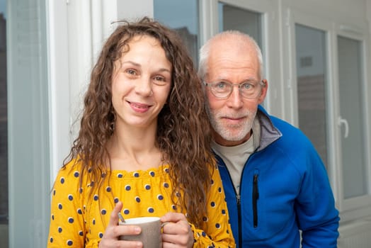 Father and daughter smiling together at home