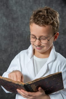 cheerful boy retro with a white blouse reading a book