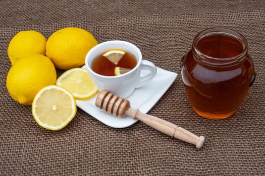 Cup of tea with honey and lemon. Spicy medicinal tea for autumn-winter season.