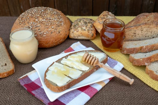 Slice bread with butter and honey for breakfast