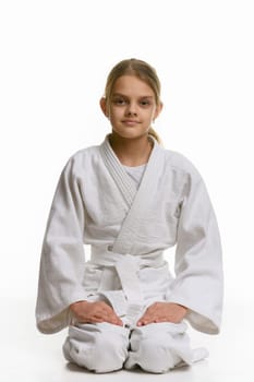 Girl in judo class, sitting on the floor