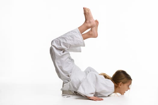 Girl judo student performs warm-up