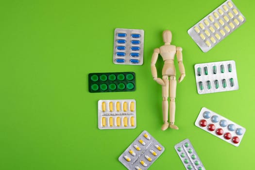 Lemon, ginger, and chapel against multi-colored tablets. The concept of choosing a healthy diet versus taking medication. Top views with clear space