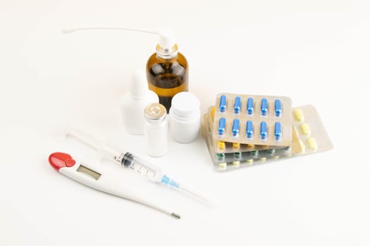 Lemon, ginger, and chapel against multi-colored tablets. The concept of choosing a healthy diet versus taking medication. Top views with clear space