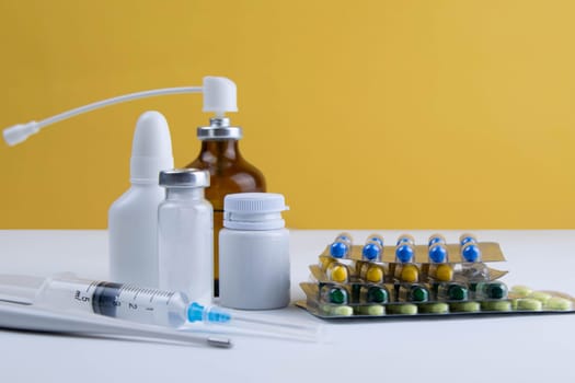 Lemon, ginger, and chapel against multi-colored tablets. The concept of choosing a healthy diet versus taking medication. Top views with clear space