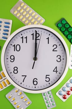 Pills of different colours lay on blue background. Colorful antibacterials pills, capsules of medicine.