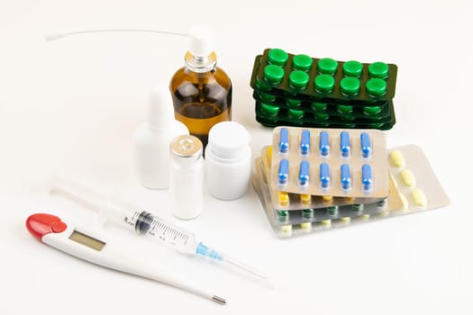 Lemon, ginger, and chapel against multi-colored tablets. The concept of choosing a healthy diet versus taking medication. Top views with clear space