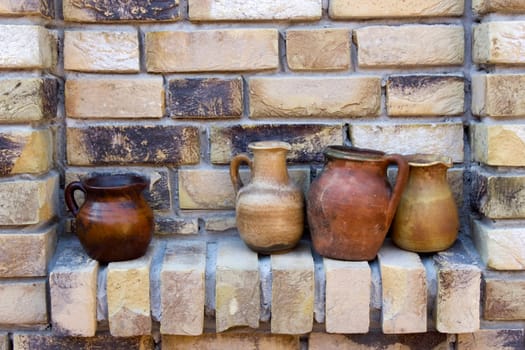 clay pots on a brick wall