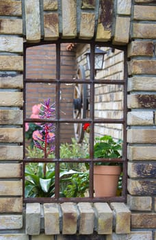 beautiful place in the garden in the mediterranean style, old window with flowers