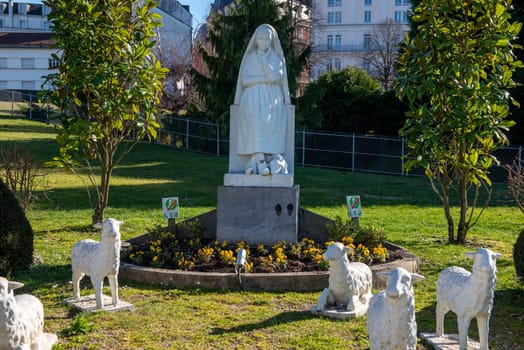 the Statue of Bernadette of Lourdes with flowers