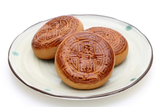 Traditional mooncake for Chinese mid autumn festival, on white background