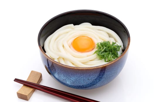 Japanese noodles in a ceramic bowl on white background