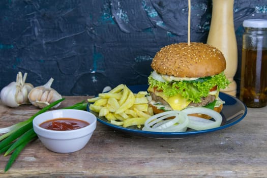 Two hamburgers close-up on a round wooden board, next to, tomatoes, chopped onions and spinach leaves.