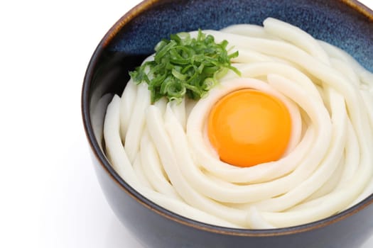 Japanese noodles in a ceramic bowl on white background