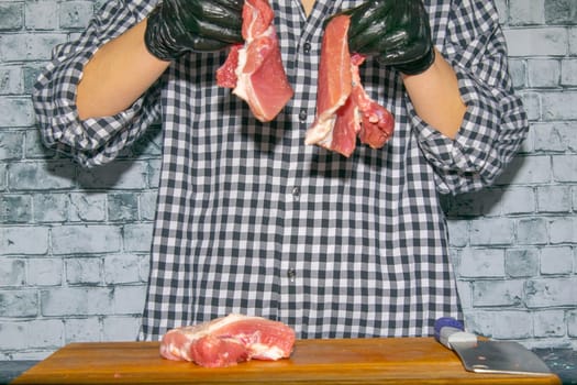 Preparing for the preparation of hamburgers. On a wooden board are lettuce leaves, chopped: tomatoes, cucumbers, onions, cutlets and sauces.