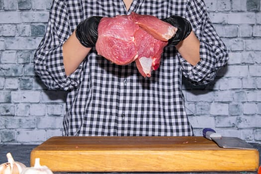 Preparing for the preparation of hamburgers. On a wooden board are lettuce leaves, chopped: tomatoes, cucumbers, onions, cutlets and sauces.