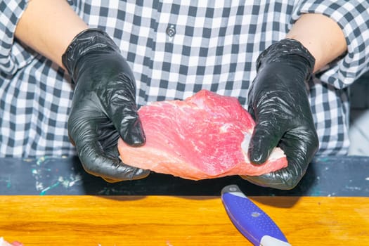 Preparing for the preparation of hamburgers. On a wooden board are lettuce leaves, chopped: tomatoes, cucumbers, onions, cutlets and sauces.