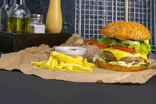 Two hamburgers close-up on a round wooden board, next to, tomatoes, chopped onions and spinach leaves.