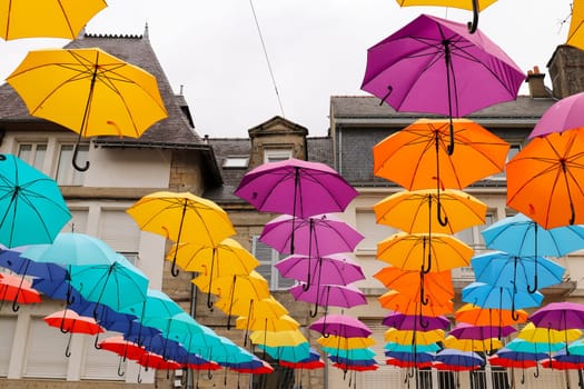 Pontivy, France, August 6, 2019: Colorful umbrellas hanging over the square du Martray. Pontivy, Morbihan, Brittany, France