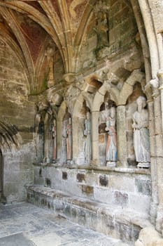 Plouha, France, August 15, 2019: Chapel of Kermaria an Iskuit - medieval wooden statues of saints - apostles - at the entrance to the chapel of Kermaria an Iskuit from 13th century