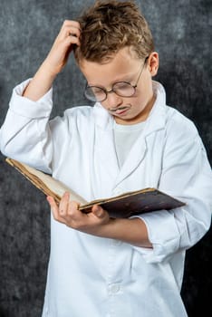 cheerful boy retro with a white blouse reading a book