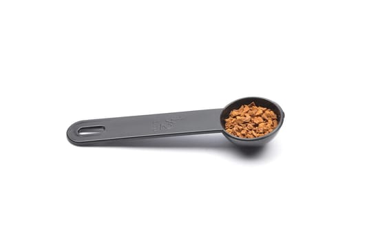 Instant Coffee with measuring spoon on white background