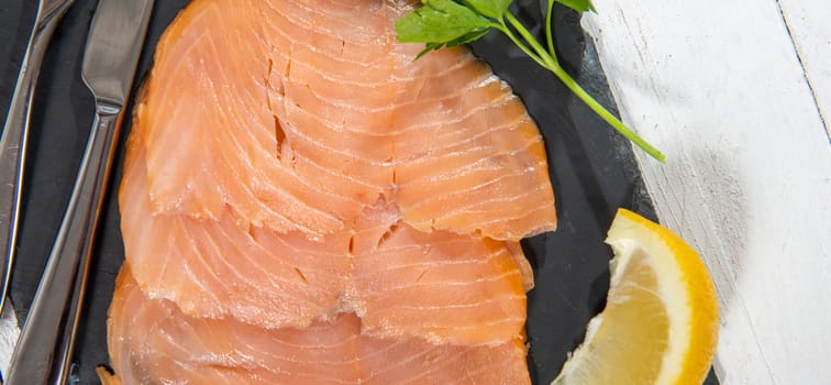Delicious raw salmon fish fillets on the white wooden
