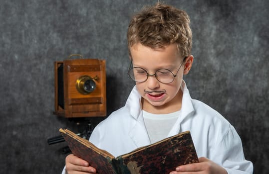 cheerful boy retro with a white blouse reading a book
