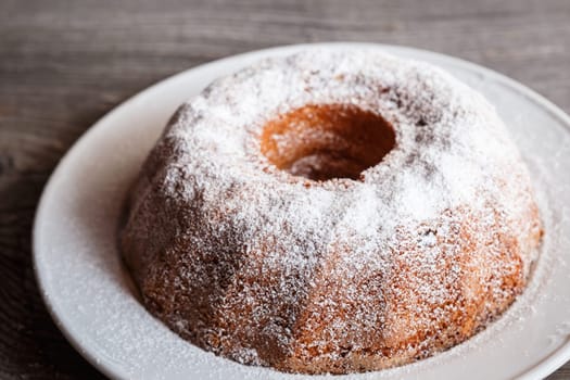Home made freshly baked whole marble cake covered with powdered sugar
