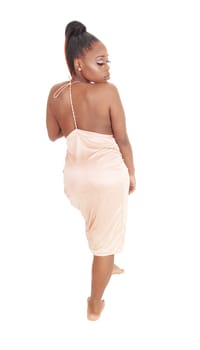 A lovely young African American woman standing from the back in.an pink evening gown, isolated for white background.